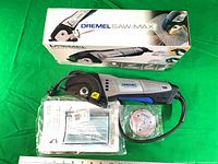 Saw-Max tool with discs, manual, damaged box visible