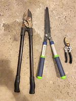 All three garden tools laid out on floor