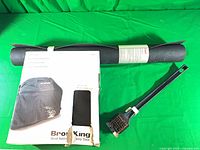 Cover box, rolled mat and brush grouped