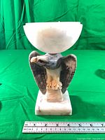 Front view of alabaster eagle lamp showing missing socket and cord, ruler for scale
