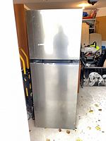 Full view of stainless steel top-freezer refrigerator