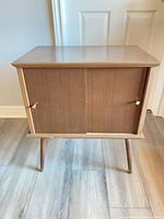 Front view of record cabinet showing sliding doors and knobs