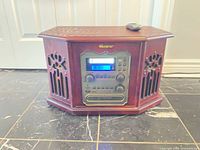 Front view of Memorex wooden stereo system showing control panel, speakers and remote on top