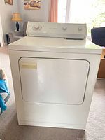 Full view of white Whirlpool front-load gas dryer