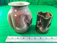 Front view of both pottery pieces with ruler for scale