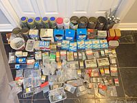 Full lot laid out on floor showing packaged and loose fasteners