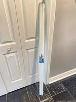 Two 48-inch fluorescent tubes leaning against wall