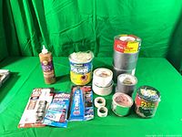 Full lot showing tape rolls, Tacky Glue bottle, sealed Flex Tape, Foilskin tape and carded adhesives
