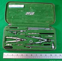 open case showing all drafting instruments laid out
