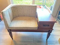 Full view of gossip bench showing upholstered seat, side table, and legs