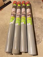 Four packaged rolls of Vitalism landscape fabric laid side by side