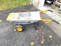 Side profile of Worx Aerocart showing tub, dual wheels, orange handles