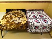 Lion and floral latch-hook rugs side by side, full view