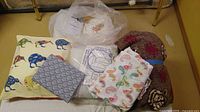 Overall lot showing pillow, fabrics, batting bag, fleece roll