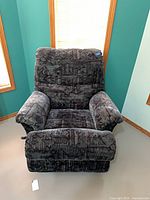 Front view of recliner in upright position showing overall fabric pattern and condition