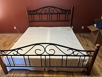 Full view of bed frame assembled showing headboard, footboard, side rails