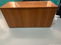 Front view of closed wood veneer chest