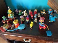 Full lot overview on wooden table showing figures, vehicles and accessories