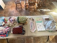 Full lot view showing multiple stacks of pre-cut fabrics, sealed template and pattern