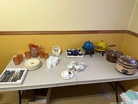 Wide view of entire mixed serveware lot on table