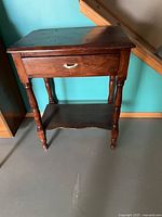 Front angled view showing overall design, drawer, shelf and legs