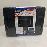Front view of sealed Helix cash box showing branding and size