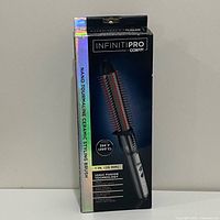 Front view of boxed InfinitiPRO by Conair nano ceramic styling brush showing features and specifications