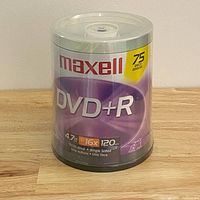 Front view of sealed Maxell DVD+R 75-pack spindle showing label and capacity details