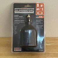 Front view of sealed Motomaster Eliminator 75W Mobile Power Outlet in retail packaging