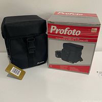 Camera case front view beside original Profoto retail box, showing tags attached