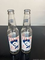 Front view showing Elvis graphics on both glass bottles with caps