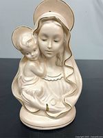 Front view of cream Madonna and Child figurine showing gold trim and facial detail
