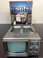 Front view of Bentley 5-inch portable television and original box