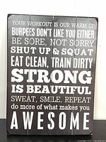 Front of wooden sign displaying motivational exercise text