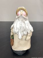 Front view showing entire Santa figurine with wreath