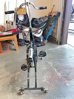 Full front view of Westinghouse Exercycle showing handlebars, gauge, seat, pedals and caster wheels