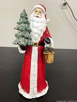 Front view of Santa figurine with tree and lantern