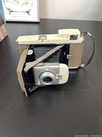 Polaroid folding Land camera opened showing bellows and lens