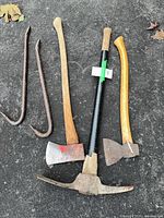 Group shot of two pry bars, single-bit axe, pick mattock, hatchet