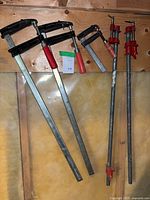 Group of five clamps hanging on wall