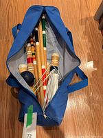 Top view of blue carry bag showing mallet handles, balls and wickets