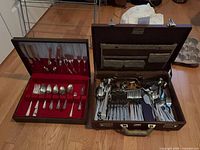 Two open cutlery cases showing contents