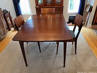 Full view of dining table with three chairs