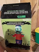 Front of box showing Airblown Big Head Monster inflatable image and branding