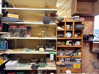 Overall view of metal shelves with jars of fasteners, organizers and accessories