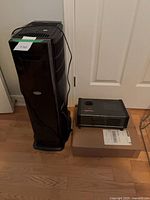Aircare tower humidifier beside Reactor space heater on floor