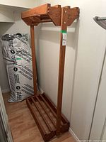 Full view of oak coat rack in closet