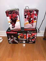 Five boxed Ottawa Senators player bobbleheads stacked