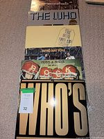 Front view of stacked album covers showing titles