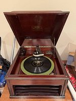 Overall view of phonograph with lid open showing platter and tonearm
